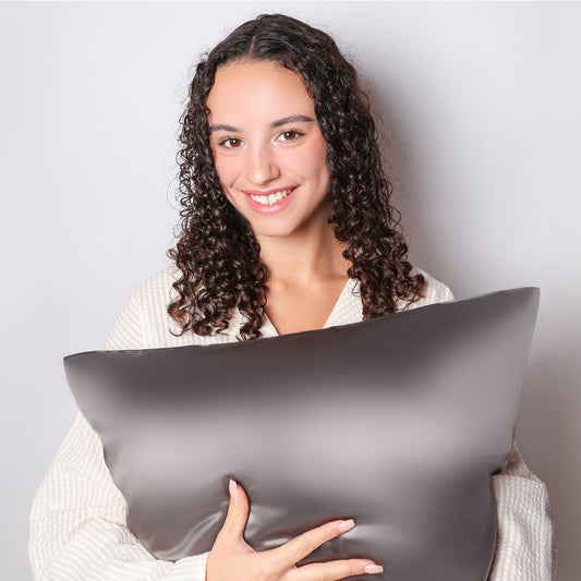 Model Holding Organic Charcoal Grey Silk Pillowcase For Curly Hair
