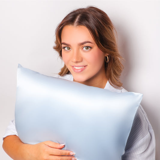 Model Holding Organic Coastal Blue Silk Pillowcase For Skin and Hair