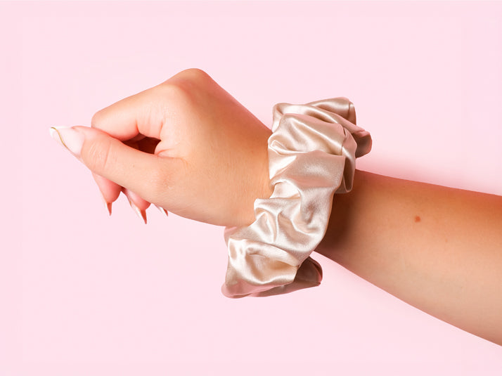 Model Waring Large Champagne Silk Scrunchie On Wrist - The SIlk Club