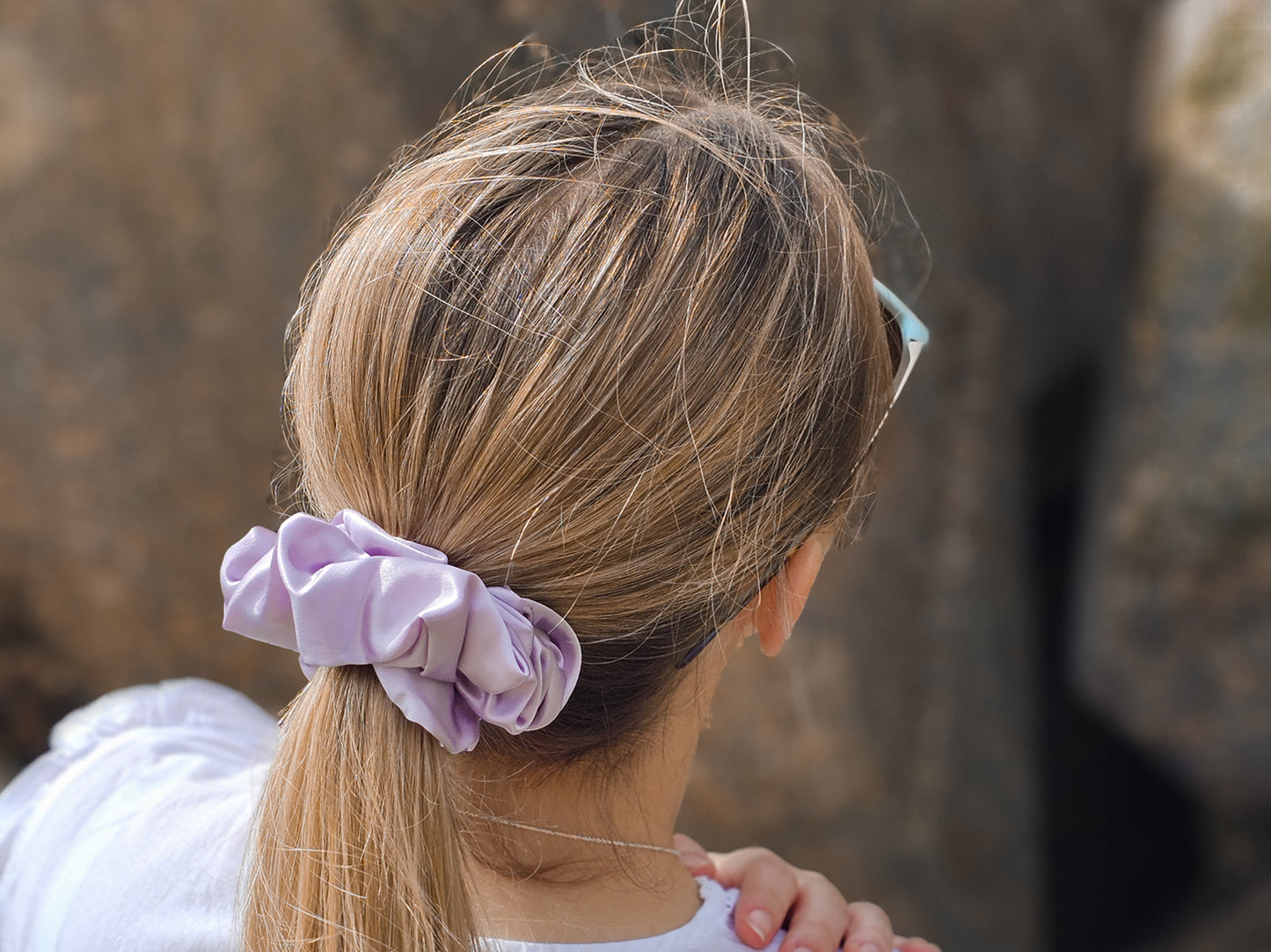 Model wearing large lilac silk scrunchie - scrunchie hairstyle ideas