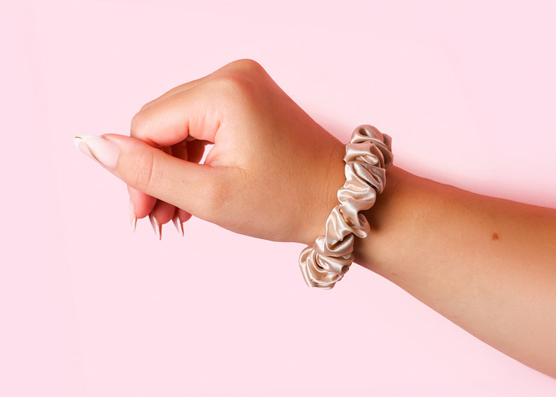 Model Wearing Champagne Midi Silk Scrunchie On Wrist - Small Silk Hair Scrunchies