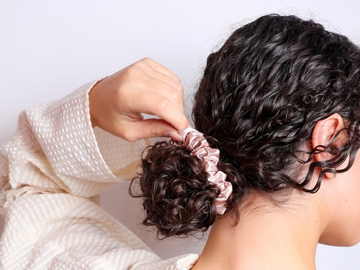Model Waring Hair Tied In A Bun With Small Pink Silk Scrunchie