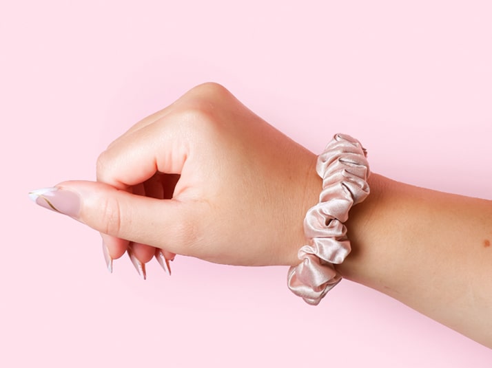 Model Wearing Small Pink Silk Scrunchie On Wrist