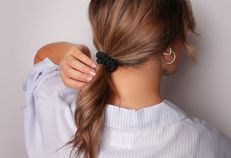 Low ponytail hairstyle with black silk hair tie