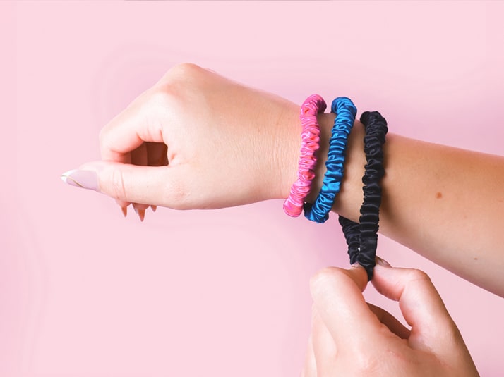 Model wearing 3 Silk Hair Ties On Wrist - Skinny Silk Scrunchies