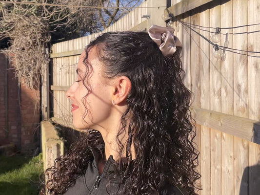 Half-up hairstyle with big rose gold scrunchie made from mulberry silk