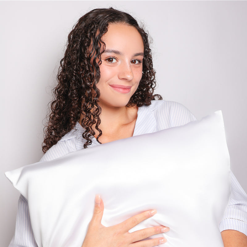 Model Holding Organic White Silk Pillowcase For Curly Hair