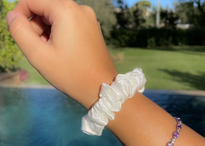 Small White Silk Scrunchie On Model's Wrist