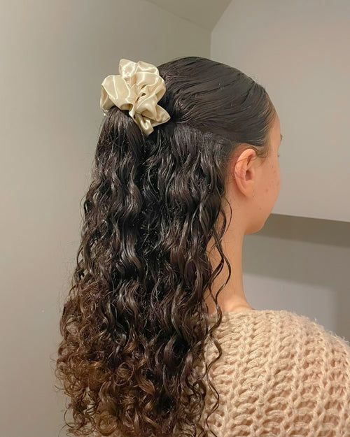 Curly Half-up Hairstyle Secured With An Oversized Champagne Silk Scrunchie
