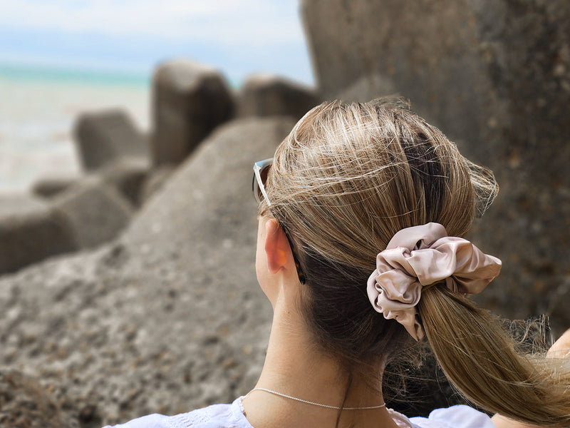 Low Ponytail Styled With A Large Oversized Pink Silk Scrunchie at The Beach