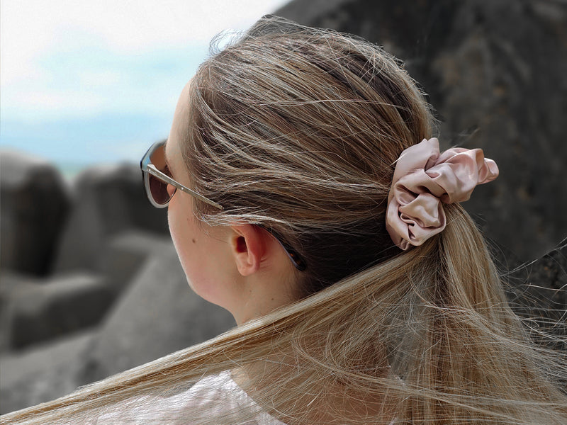 Pink Statement Scrunchie Styled In A Low Ponytail At The Beach - Beachy Hairstyles