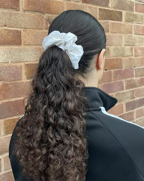 Curly Low Ponytail Styled with Big White Silk Scrunchie - Scrunchie Hairstyle Ideas