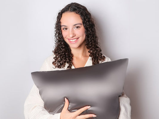 Model holding Charcoal Grey Mulberry Silk Pillowcase