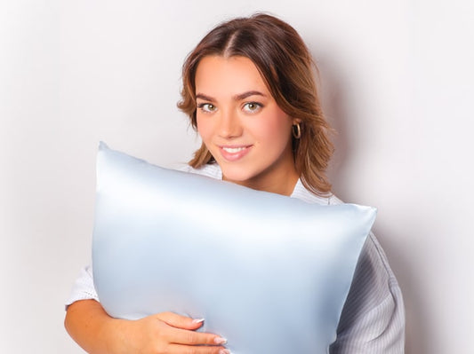 Model holding Coastal Blue Mulberry Silk Pillowcase