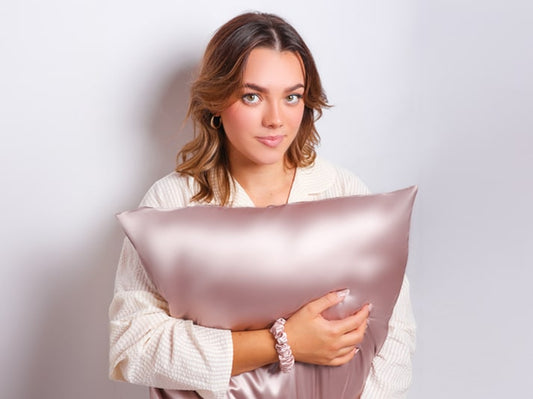 Model Holding Rose Gold Silk Pillowcase