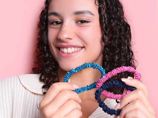 Model holding Azure Blue, Flamingo Pink & Navy Blue Silk Hair Ties