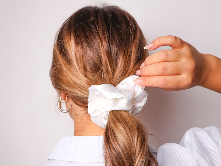 Model Wearing The Silk Club Large White Silk Scrunchie