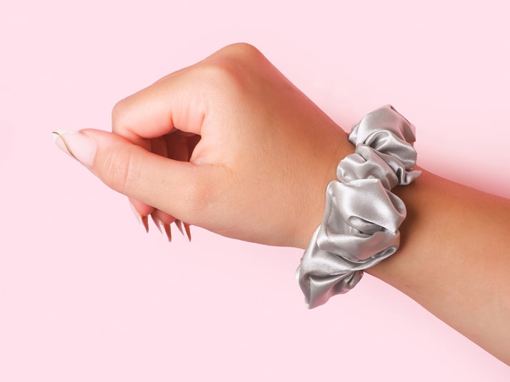 Model Wearing Silver Silk Scrunchie On Wrist - The Silk Club