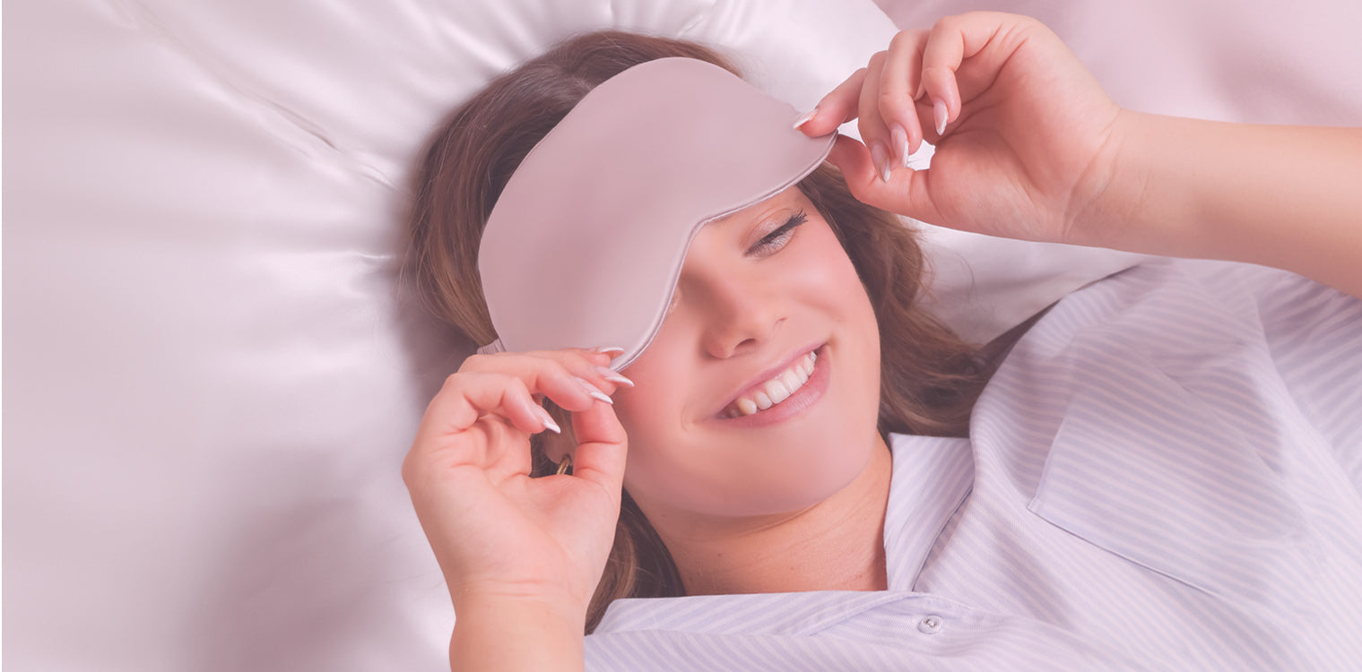 Model relaxing on a silk pillowcase wearing a silk eye mask