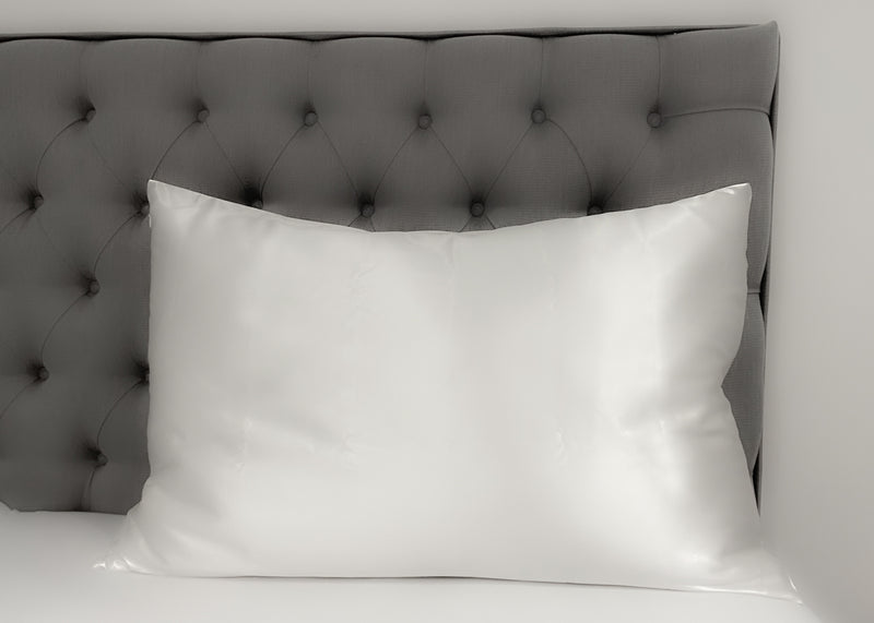 White Silk Pillowcase Against Grey Headboard